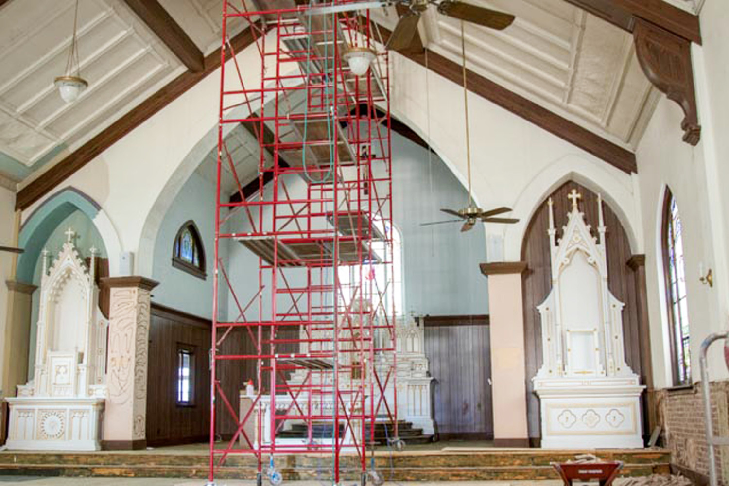 Scaffolding allows plasterers and painters to reach the ceiling of the sanctuary and nave of the church.